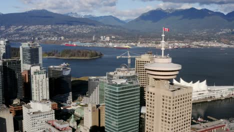 vancouver lookout at harbour centre with canada place in background in canada - aerial drone shot