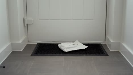 parcel delivery laying on doormat after being posted through letterbox