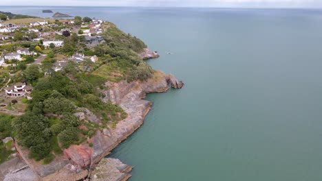 coastal town of torquay, england - aerial view above rocky sea cliffs