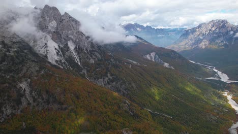 Astonishing-range-panorama-with-valley-down-the-Alps-gigantic-mountains-and-colorful-forests