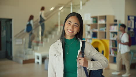 portrait of a smiling teenager in a school library