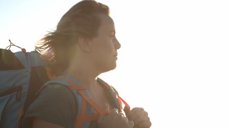 peaceful female backpacker standing outdoors