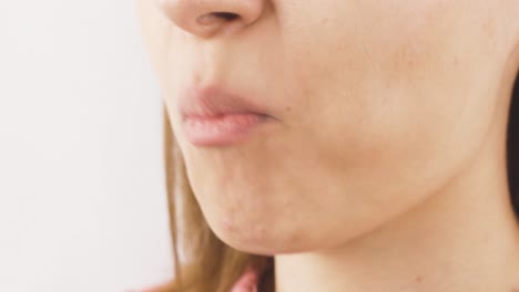 woman eating chocolate dragee in close-up. chocolate.