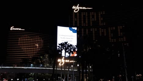las vegas at night, wynn encore hotel - casino billboard with coronavirus messages during lockdown, nevada usa