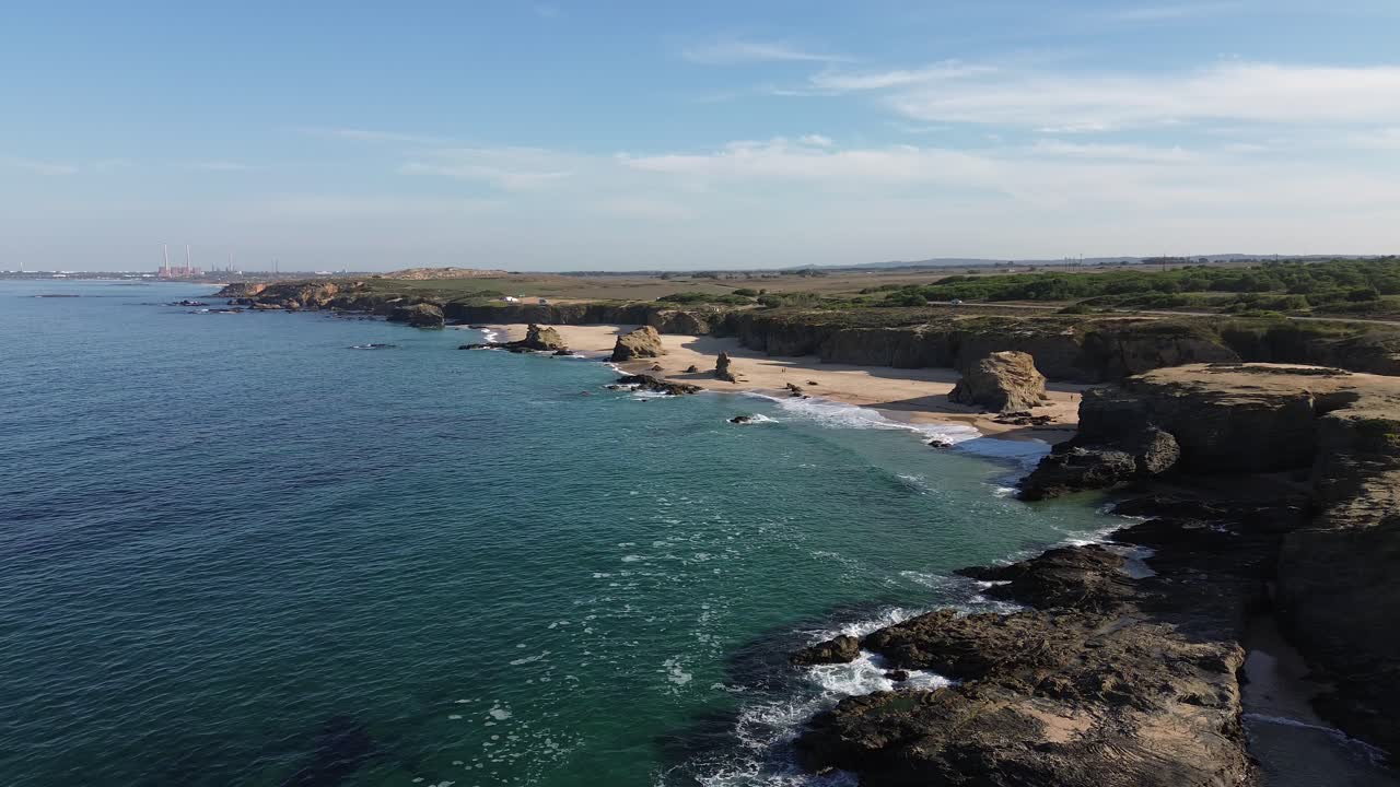 Coastal view by drone of a rocky beach with waves coming in