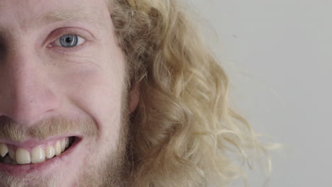 close up young blonde man smiling happy bearded caucasian male on white background half face expression