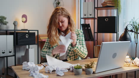 angry furious businesswoman throwing crumpled paper nervous breakdown at office work losing temper