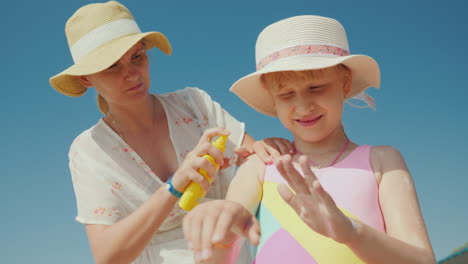 mom puts sunscreen on the skin of her daughter rest and sun protection