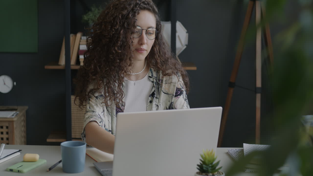 Woman Working on Laptop in a Home Office