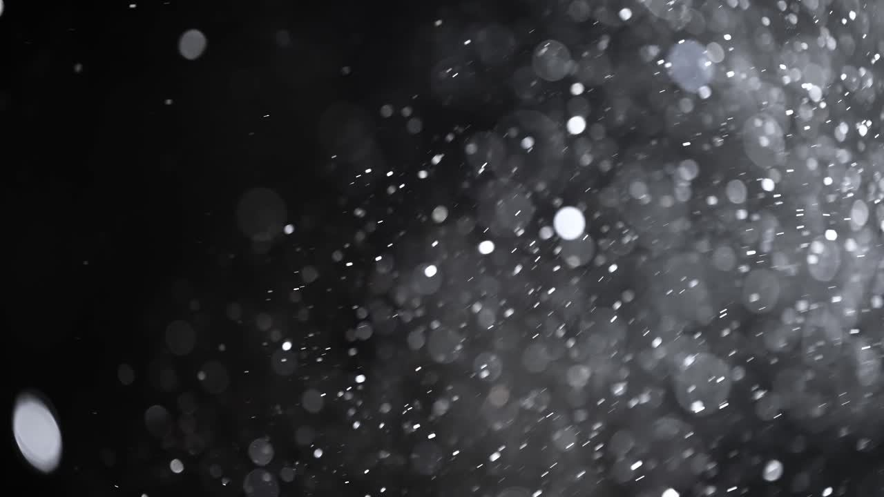 Floating abstract particle bokeh on dark background