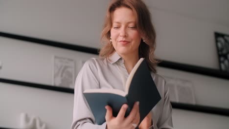 woman reading a book in an office setting