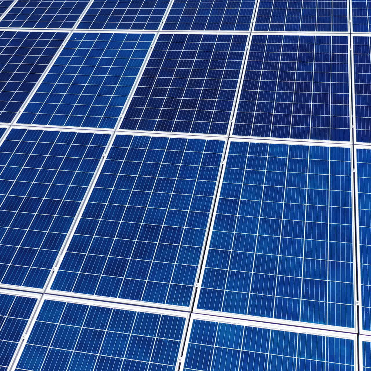 Flight over working energy batteries. Solar batteries work on a roof to accumulate the sunlight. Close-up.