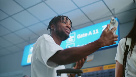 man taking a selfie in the airport