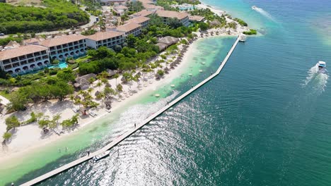 Aerial-orbit-around-Sandals-Beach-resort-and-dock-on-sunny-beautiful-Caribbean-day