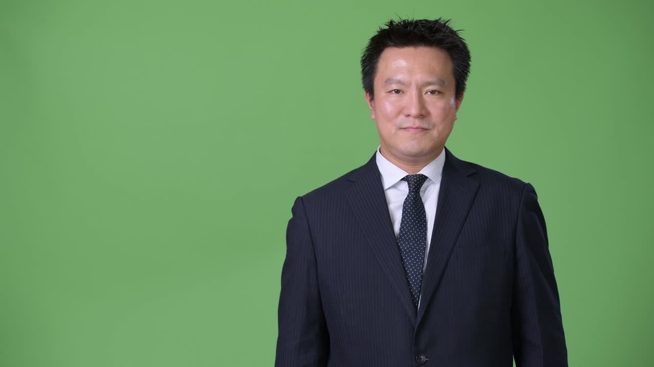 녹색 배경에 성숙한 일본 사업가