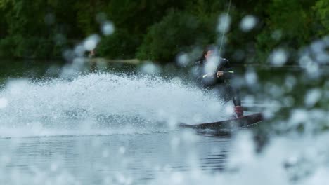 Wakeboarder-making-tricks-on-waves-during-movement-in-slow-motion.-Extreme-sport