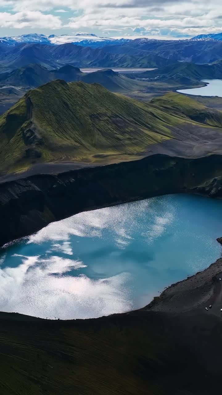 High birds eye view of crater filled with blue water in Iceland. Vertical aerial