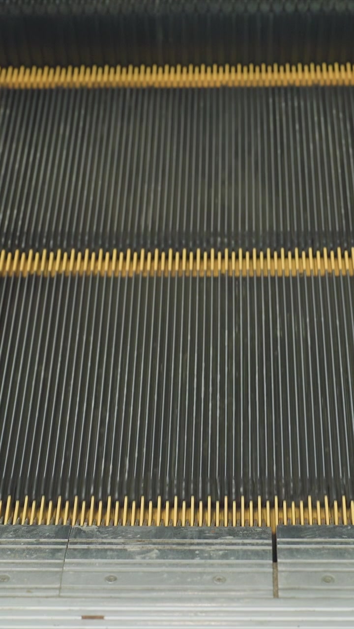 Yellow lined stairway in continuous upward movement. Surface interaction shows wear patterns from continuous use. Scene captures functional elements within utilitarian environment