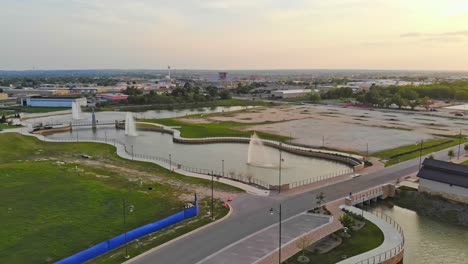 Moving-back-quickly-from-large-three-fountain-space-with-yet-to-be-developed-retail-and-restaurant-lots-in-the-background