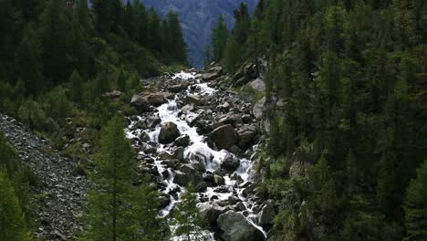 stream flowing over rocks at the mountain trails of alpe ventina in chiesa, valmalenco, sondrio, italy