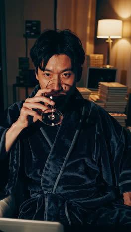 man drinking wine at home