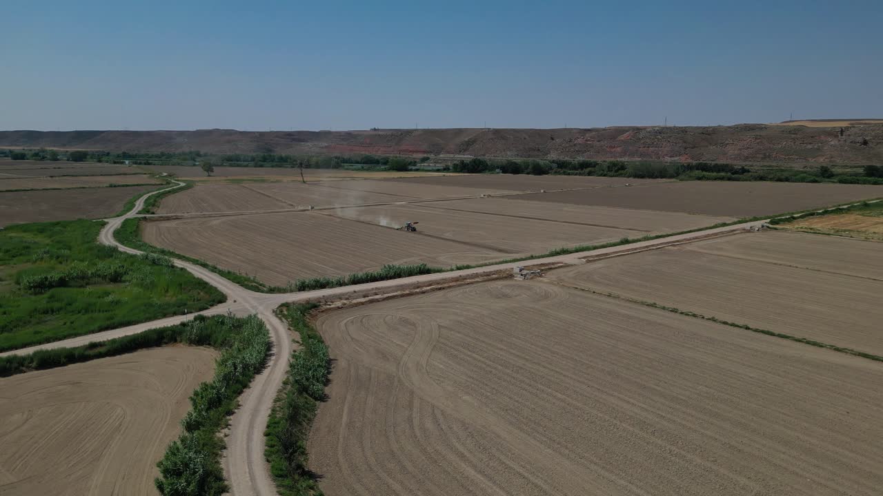 Aerial View of Tractor Working in Agricultural Fields