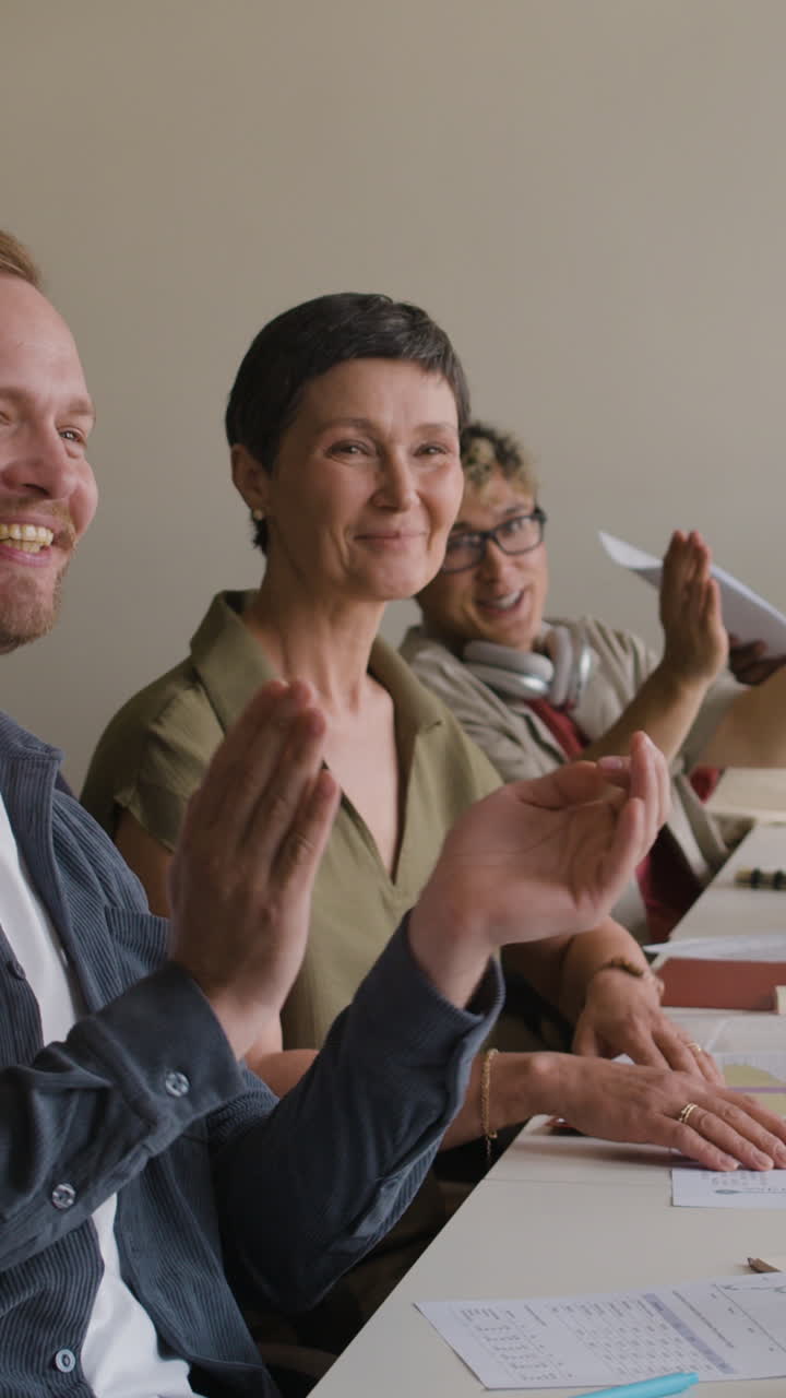 People clapping and engaged at a business meeting or educational seminar