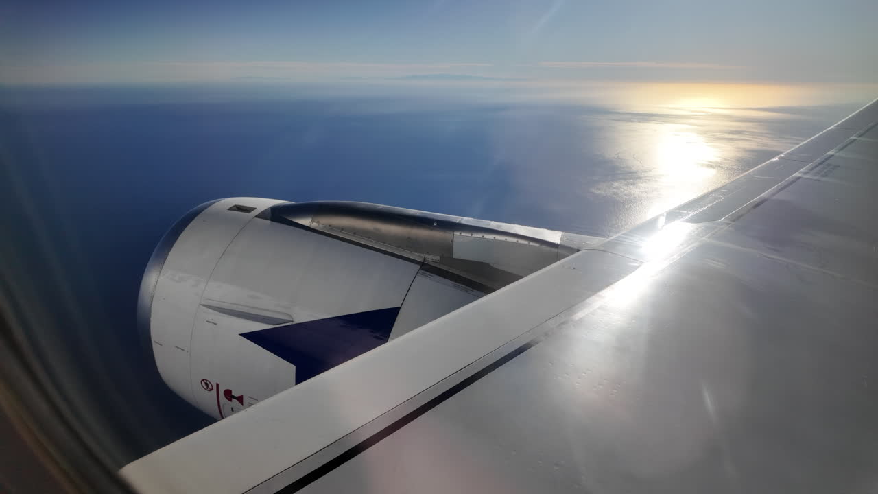 View from an airplane window of an airplane taking off above the sea