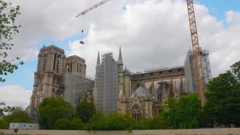 Tower-Crane-At-Work-Lifting-And-Transporting-Construction-Materials-At-The-Rebuilding-Site-Of-Notre-Dame-de-Paris-Cathedral-In-Paris,-France