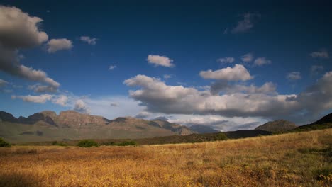 Time-Lapse-of-clouds-passing-over-a-mountain-range-at-sunset