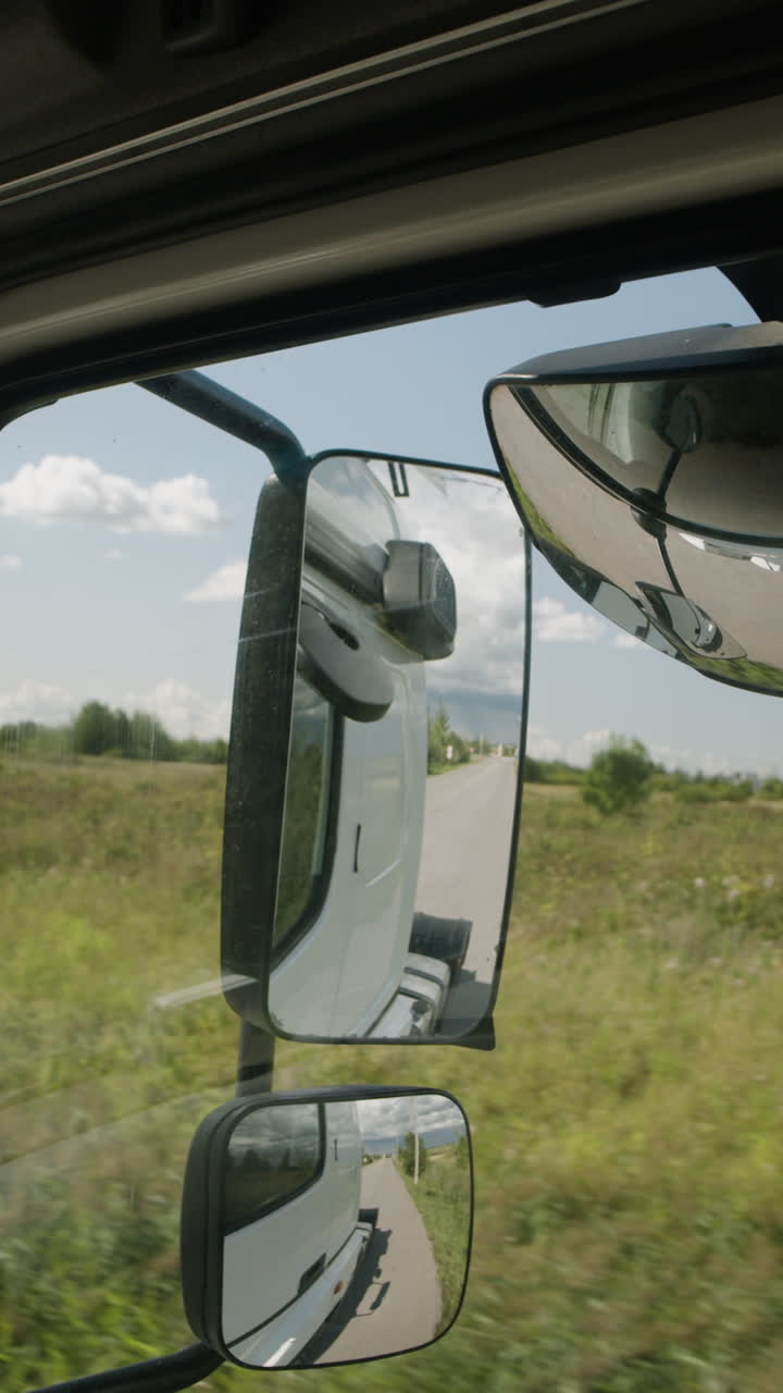 View through truck side mirror on a sunny day