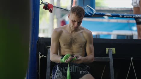 fighter prepares hands before training in a boxing ring