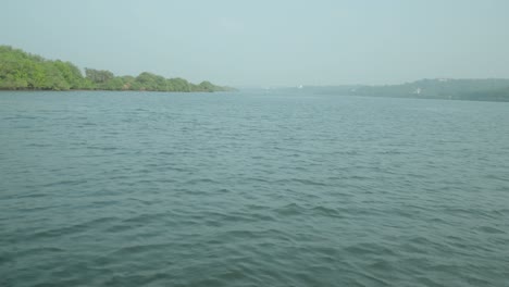 a calm body of water with trees in the background