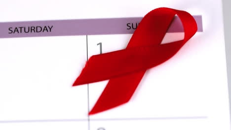 Red-ribbon-falling-on-a-calendar-