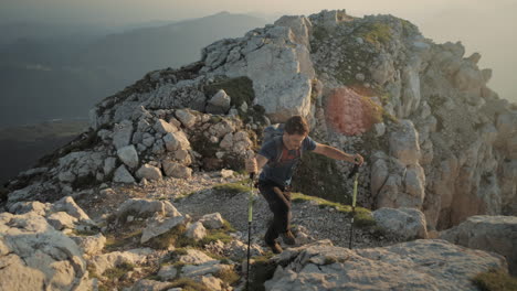 Hiking-climbing-up-a-mountain-in-early-morning-on-a-rocky-path