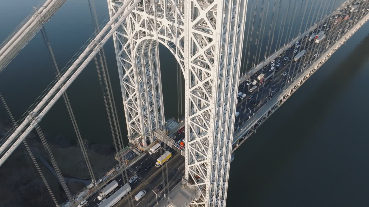 Aerial view of rush hour traffic crossing New York City’s George Washington Bridge. Shot at sunrise.