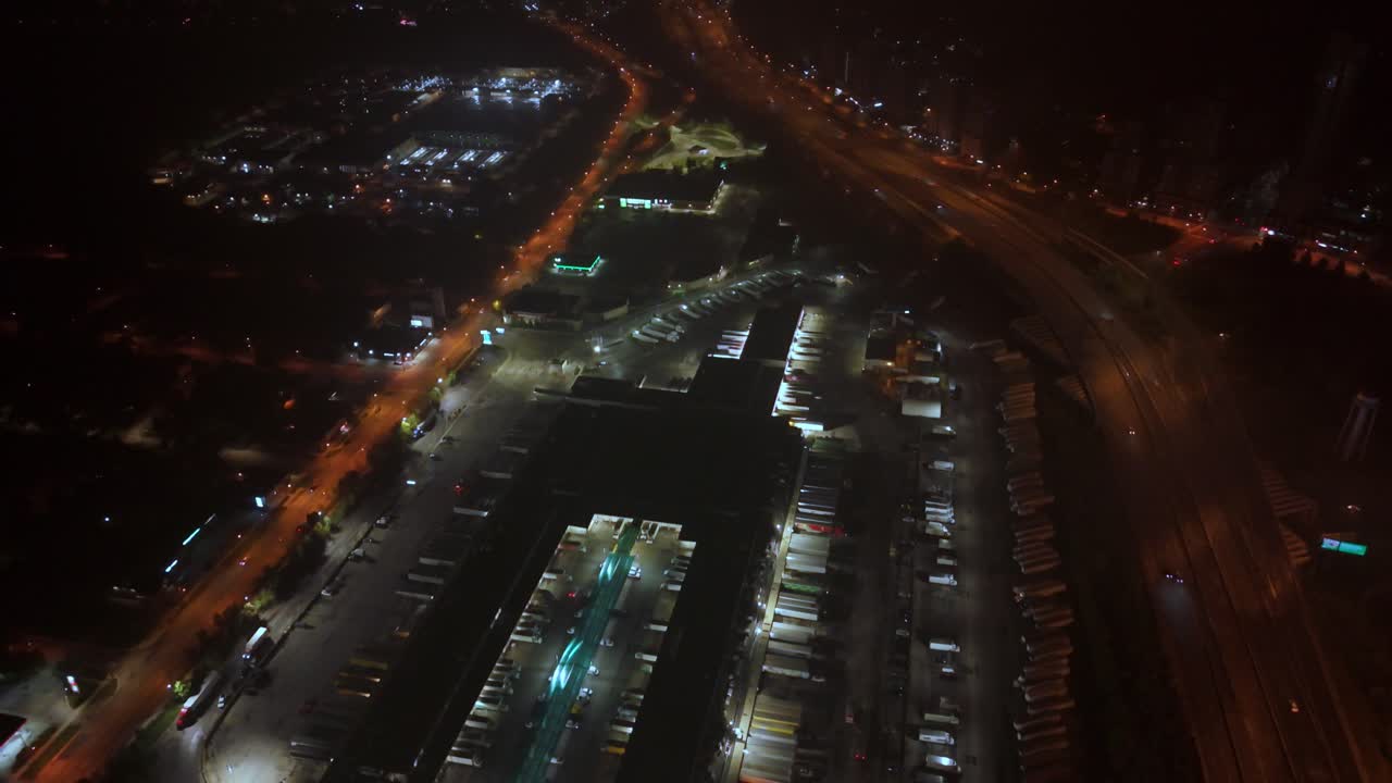 Aerial view showing dynamic movement of vehicular traffic on illuminated highways at night around downtown Toronto. Canada