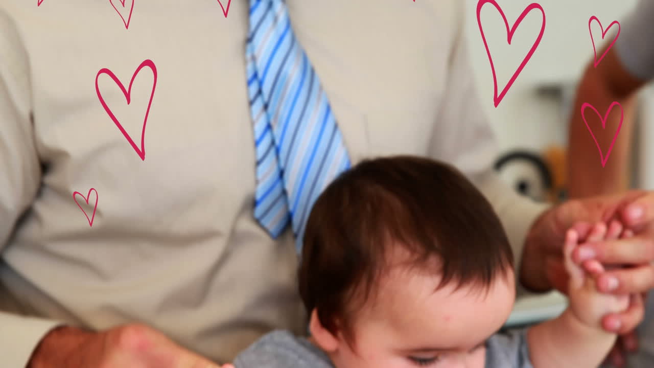 아기와 함께 행복한 백인 아빠에 대한 떨어지는 마음의 애니메이션