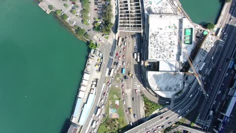 Downtown-Hong-Kong-daily-traffic-surrounded-with-city-skyscrapers,-Aerial-view