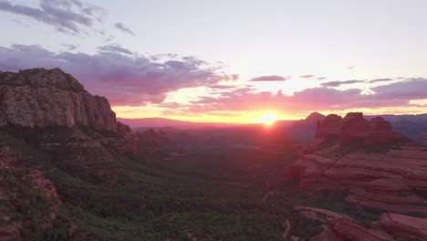 red yellow golden rays from sun cast over hiking trail to merry go round red rock canyon of sedona arizona