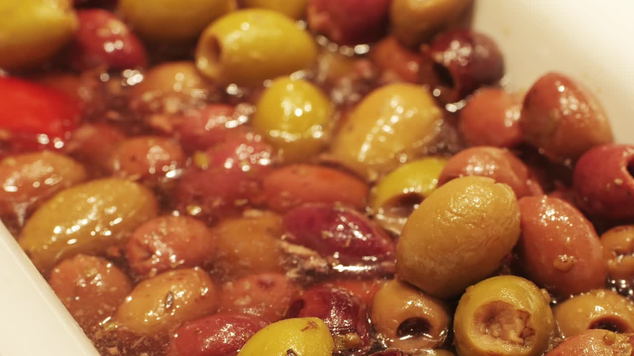 Marinated green olives in spicy sauce, spanish traditional food, ideal for Mediterranean dish or snack, market in barcelona.