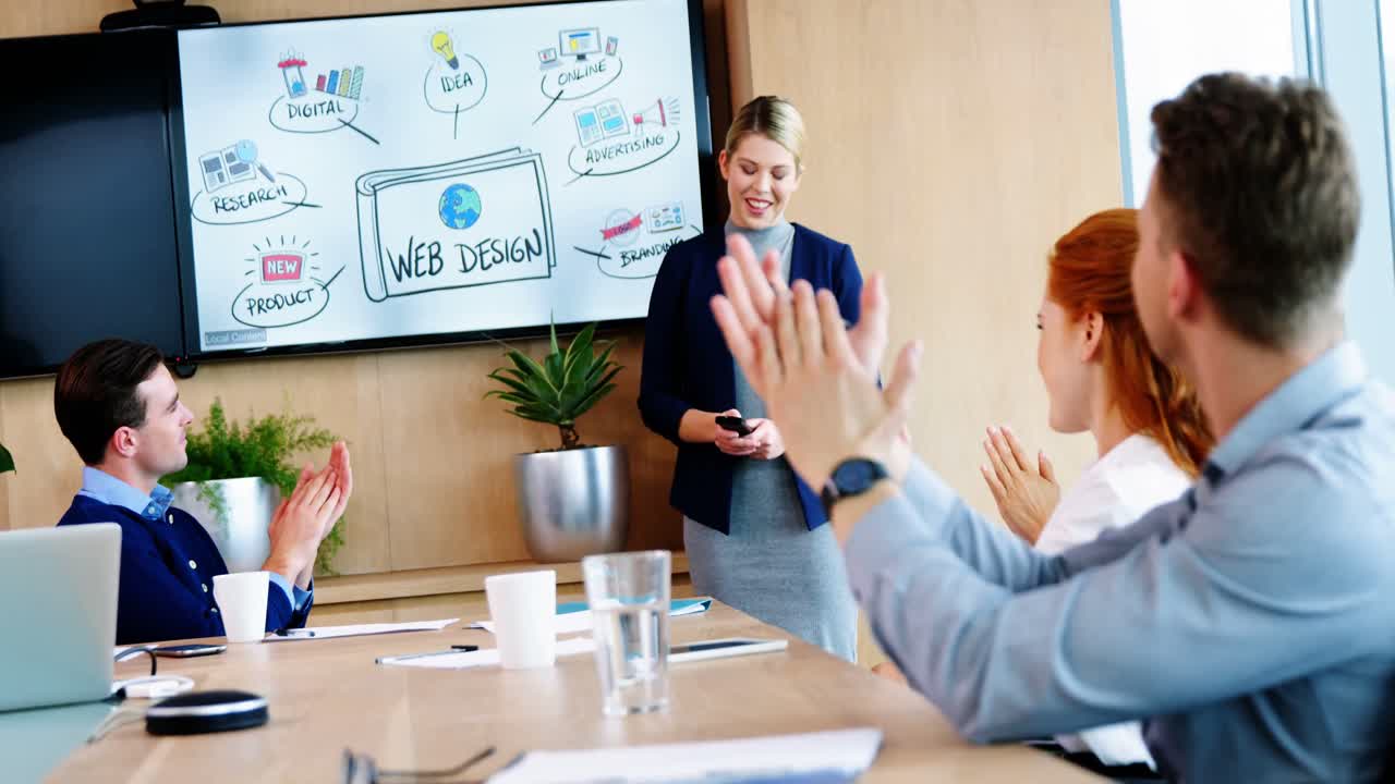 Executives applauding in conference room