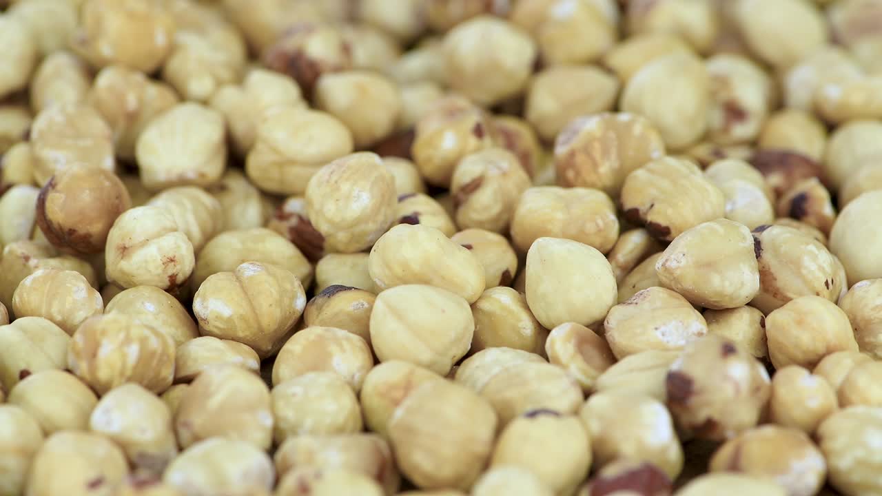 Peeled Hazelnuts on a rotating plate (seamless loopable)