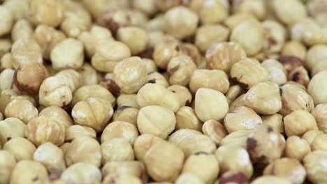 peeled hazelnuts on a rotating plate (seamless loopable)