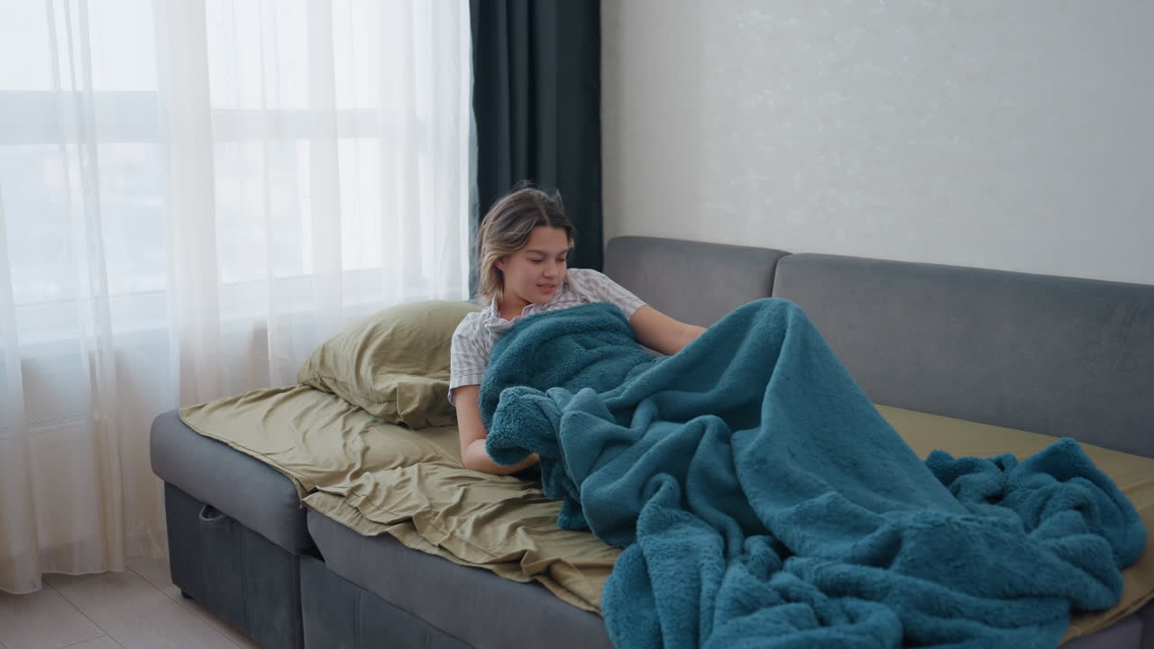 Morning Light Greets Sleeping Woman, Sunrise Illuminates Woman Stretching On Sofa, Soft Morning Sunlight Streams Through Window As Woman Awakens And Stretches Peacefully On Her Sofa