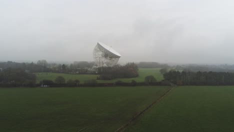 aerial jodrell bank observatory lovell telescope lowering across misty rural countryside