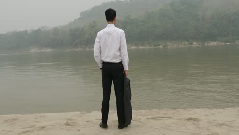businessman by the river in fog