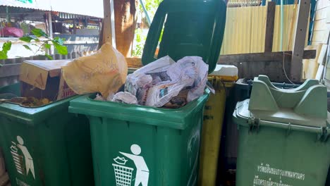 trash bins filled with waste at floating market