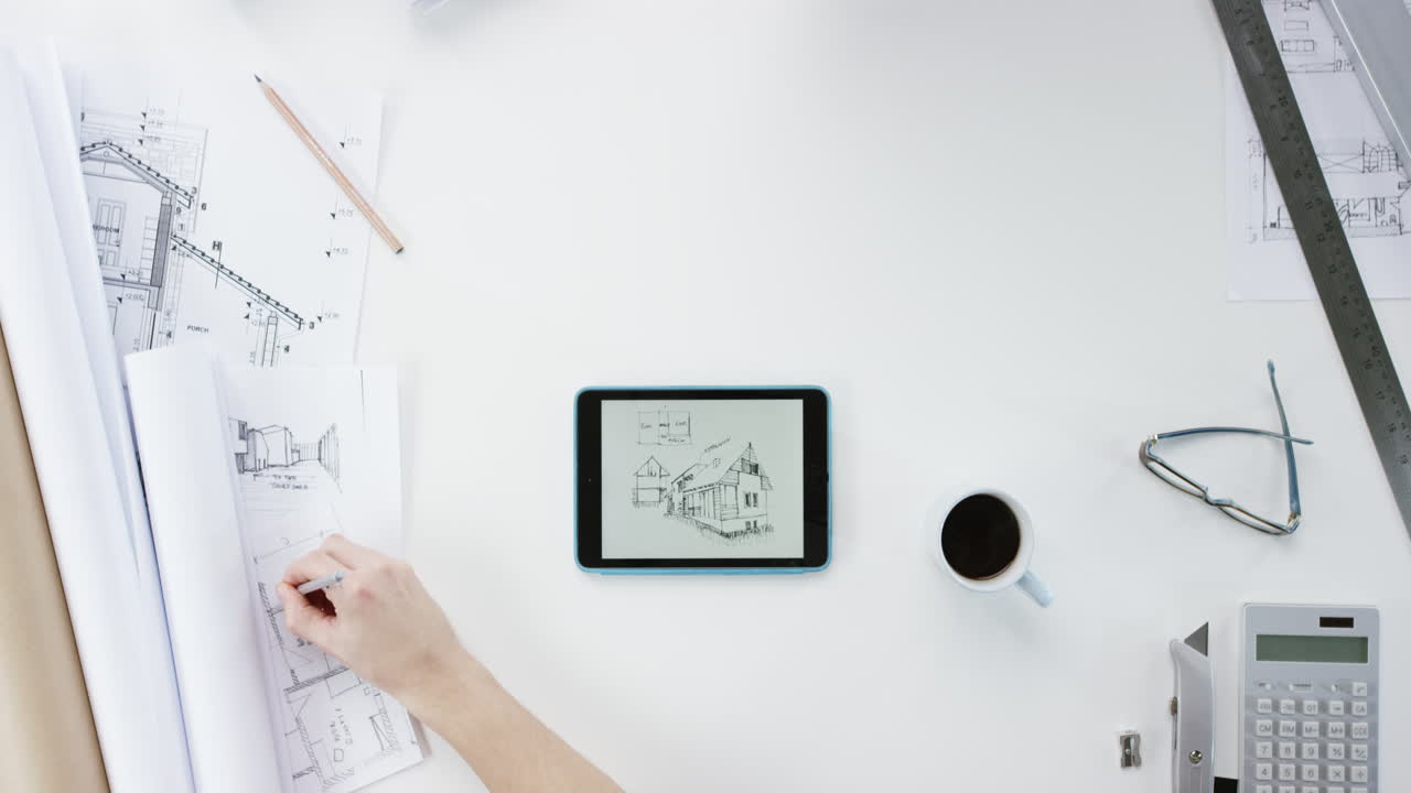 탑 뷰 아키텍트가 디지털 태블릿 손을 사용하여 연결된 집을 설계합니다. 위에서 책상에서 일합니다. 빨간 서사시 드래곤