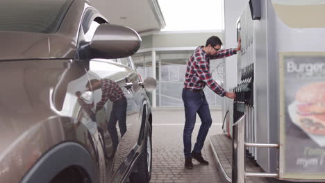 man filling gas at a gas station